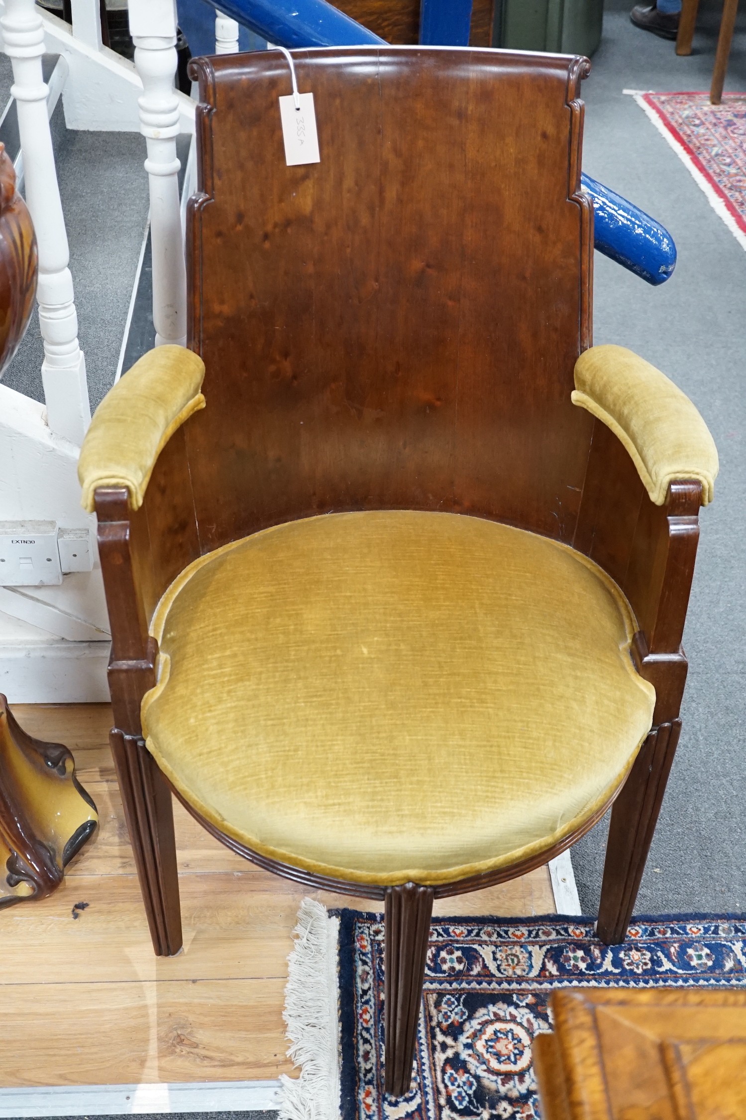 A stylish Art Deco mahogany elbow chair by Trollope and Son, numbered 4088, height 95cm *Please note the sale commences at 9am.